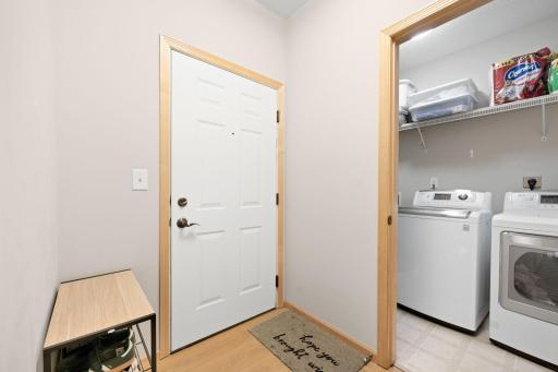 Welcoming entry with durable flooring and convenient access to the spacious in-unit laundry room.