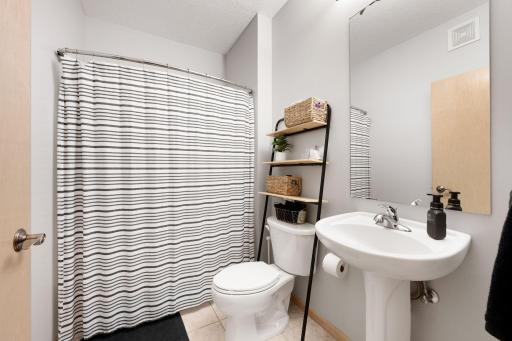 Full bath with neutral finishes, shower/tub combination, and functional layout.