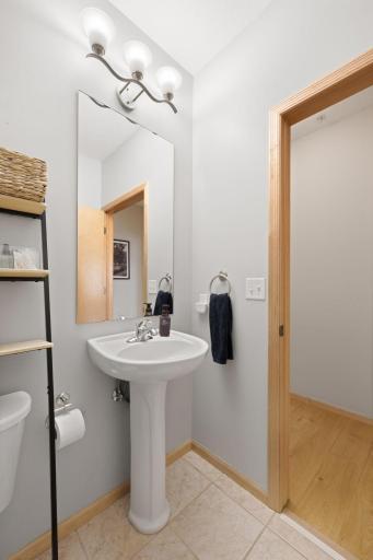 Clean and bright bath vanity area with modern lighting and simple design.