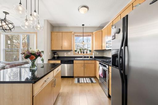 Spacious kitchen with center island seating, ample cabinetry, and stylish modern lighting.