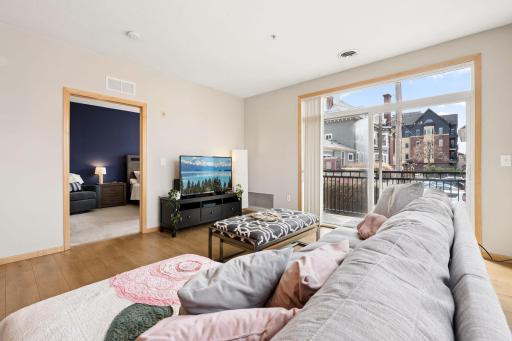 Spacious living area with balcony access and easy flow to the adjacent bedroom.