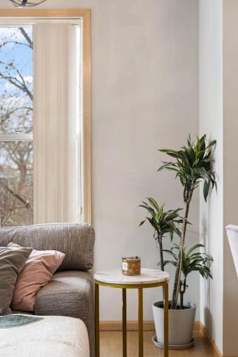 Bright living area detail with large windows and a warm, inviting feel.