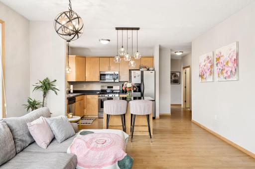 Open-concept living and kitchen space with stylish lighting and generous room to entertain.