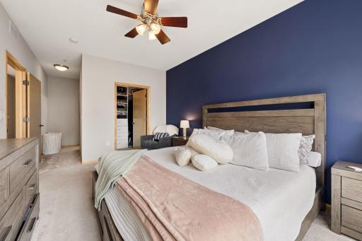 Primary suite showcasing the spacious layout and bold accent wall.