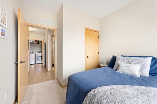 Secondary bedroom with easy access to the hall, bath, and laundry area.