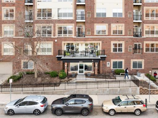 Front aerial view showcasing the welcoming entrance and prominent street presence.