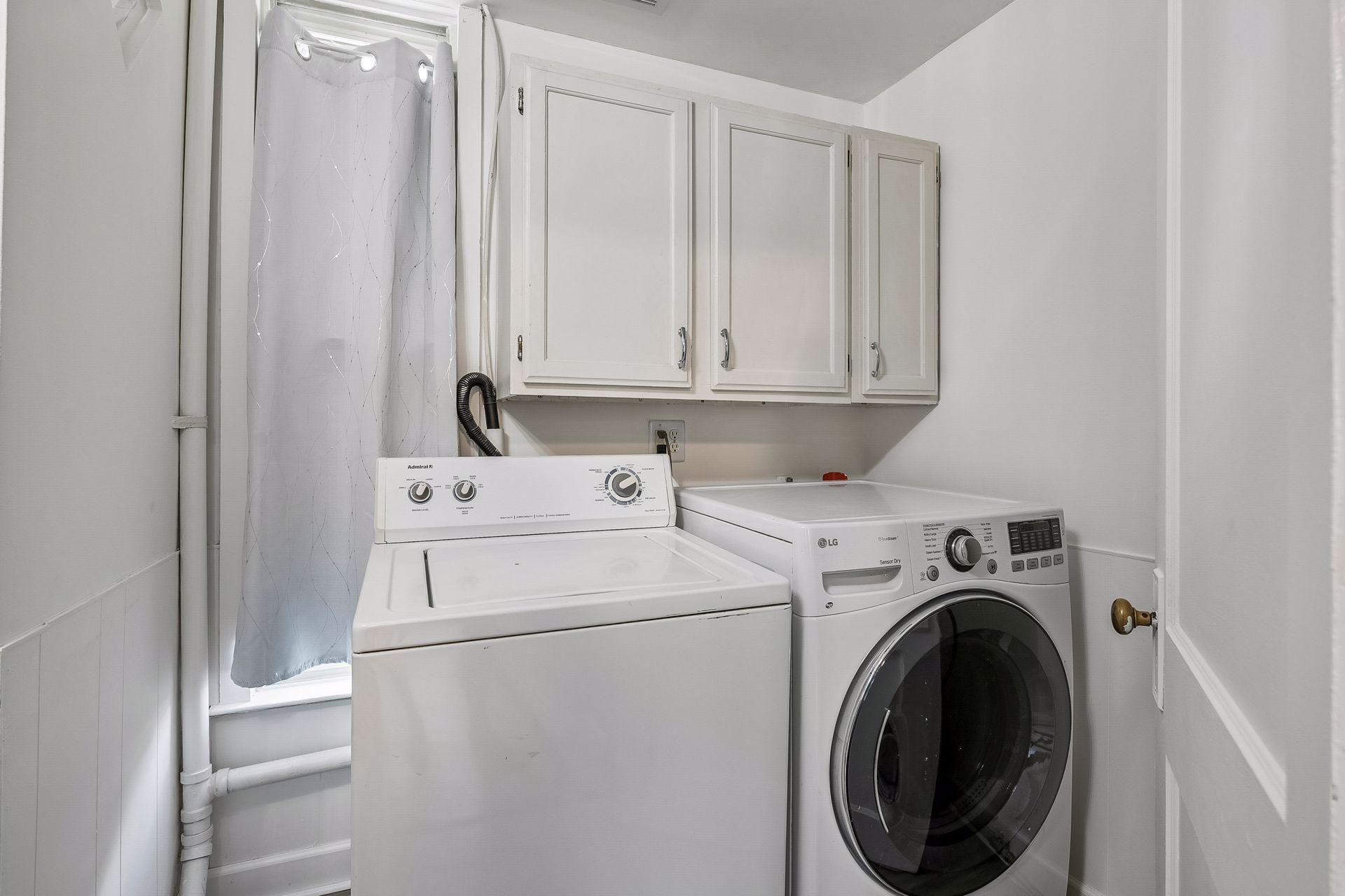 Main floor laundry closet shared with the main floor bath.