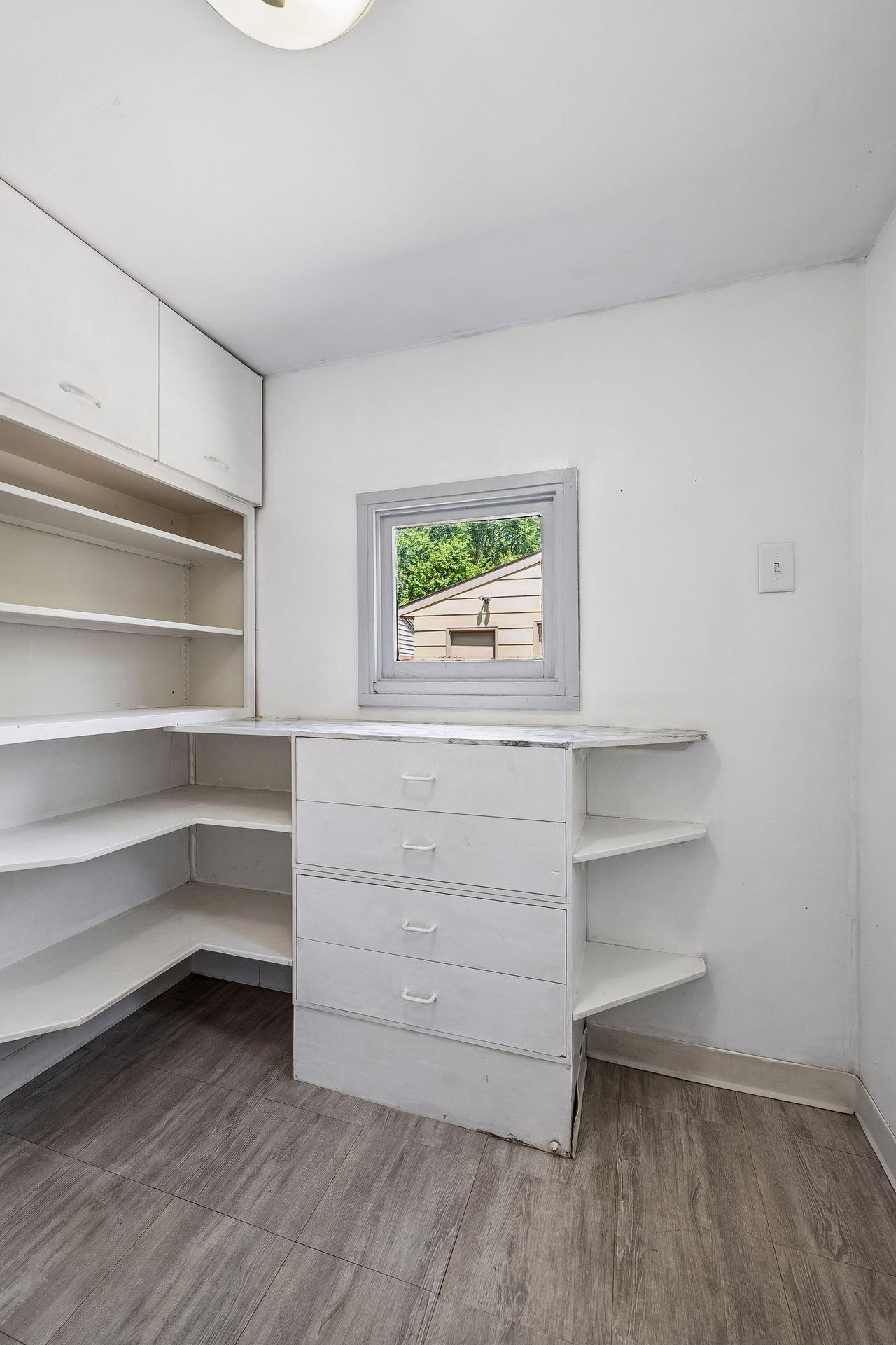 Rear mudroom with built-in shelving off the kitchen and walks out to the backyard.