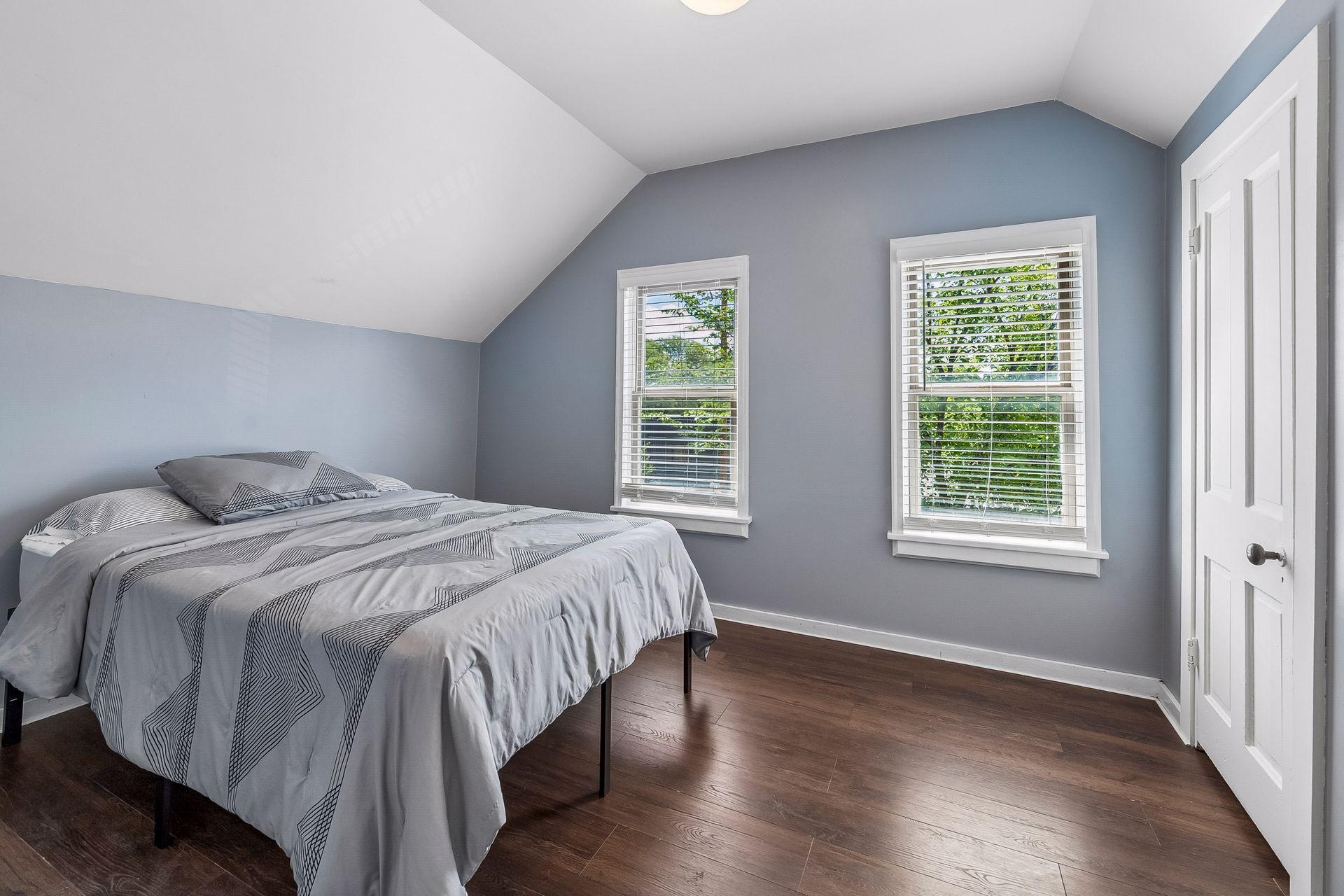 One of two upper level bedrooms with new LVP flooring and paint in 2022.