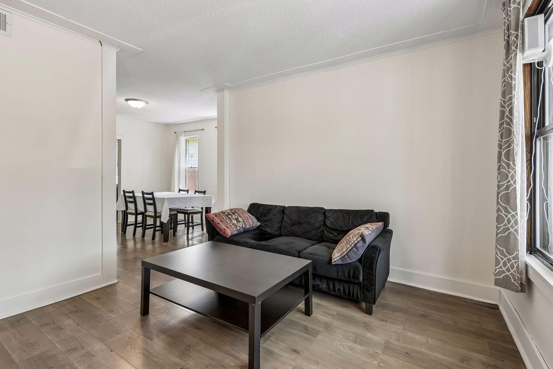 The main floor features high ceilings with a racetrack design, luxury vinyl plank flooring and oversized tall windows. Living room was painted in 2025.