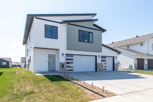 Featuring modern 5-panel glass garage doors