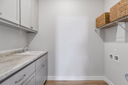Laundry room with sink and storage for added convenience