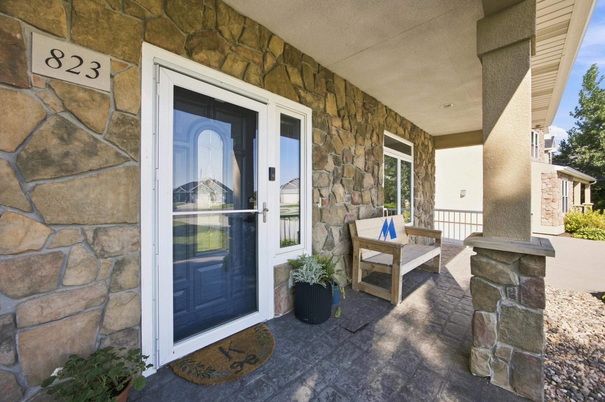 Welcoming front entrance with stamped concrete covered porch.