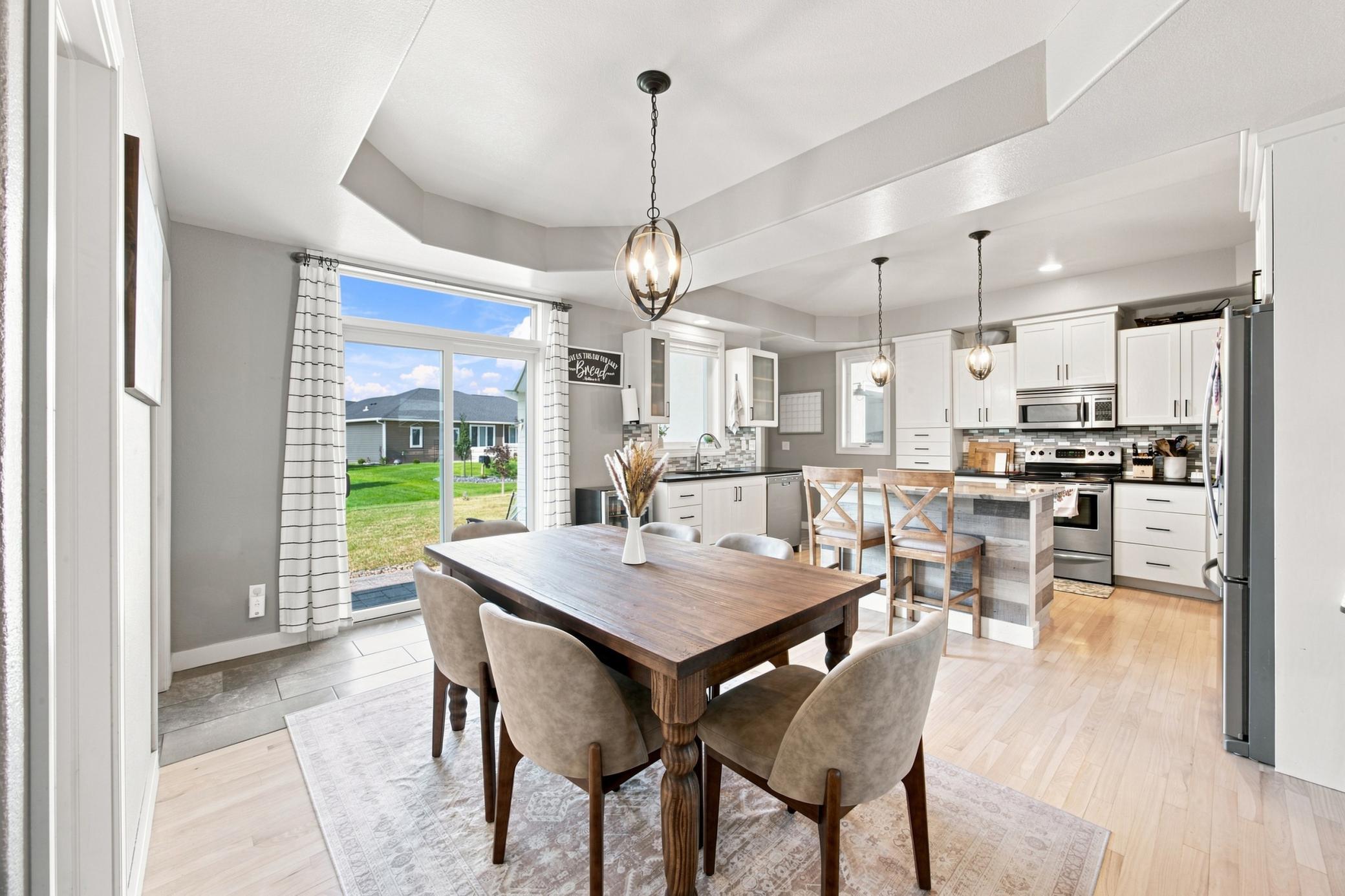 Dining area with trey ceiling and patio doors to patio/backyard.
