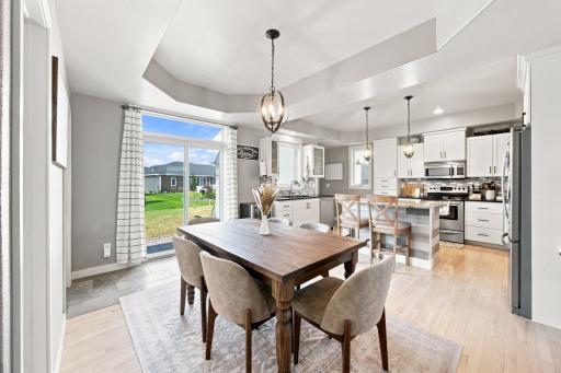 Dining area with trey ceiling and patio doors to patio/backyard.