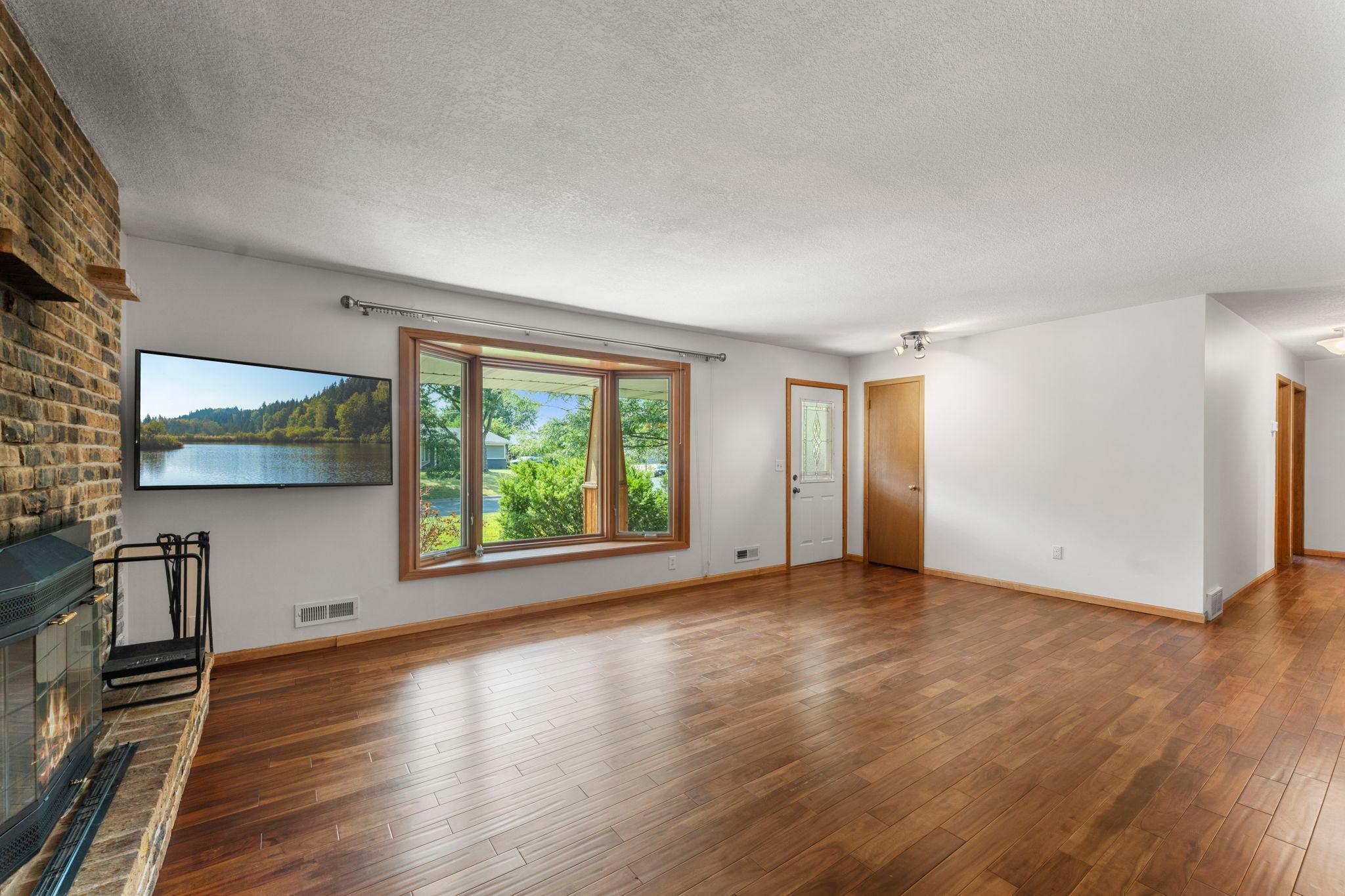 The front living room feels especially inviting with a bay window and abundant natural light.