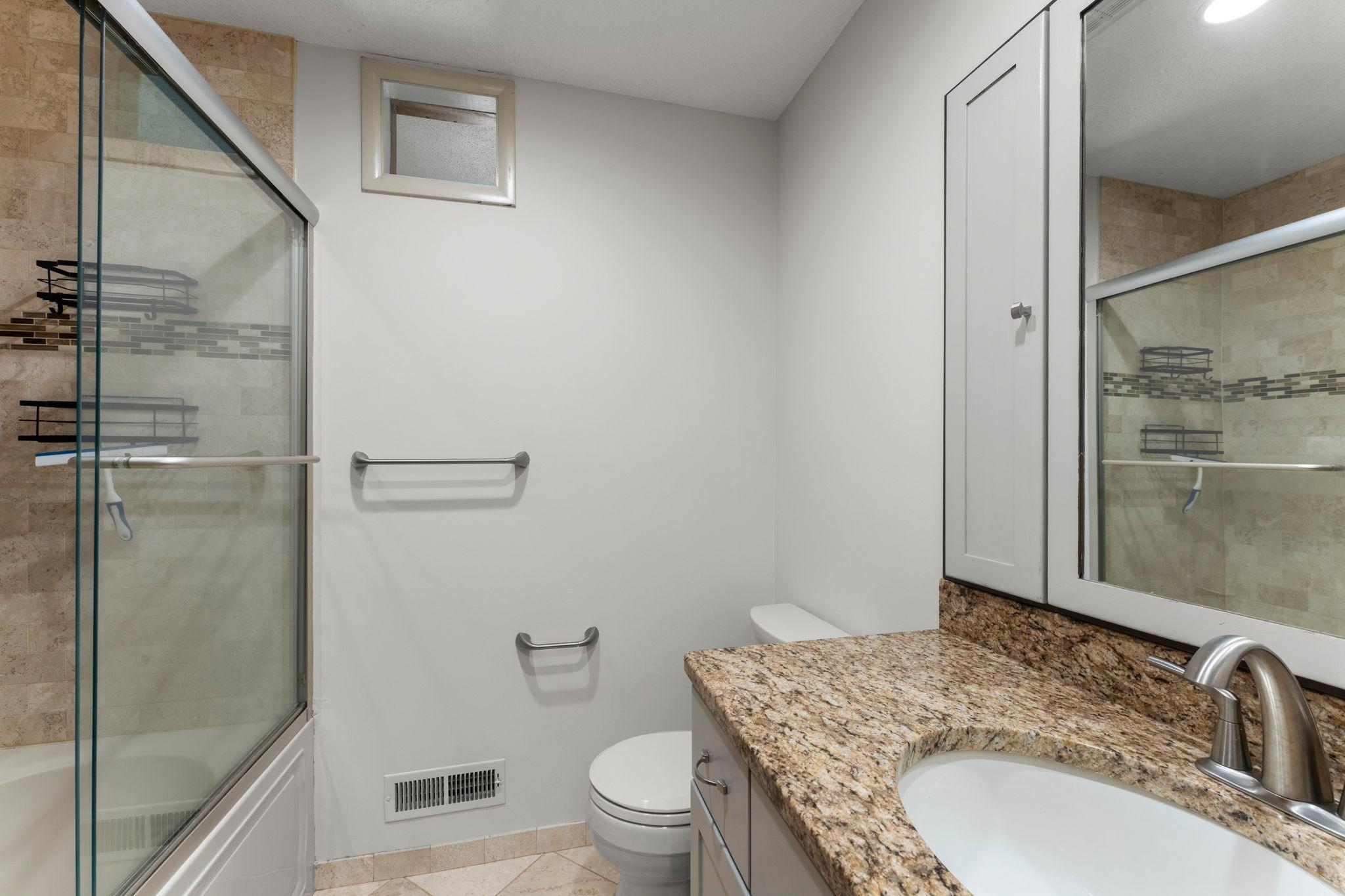 Centrally-located full bathroom with abundant hall storage.