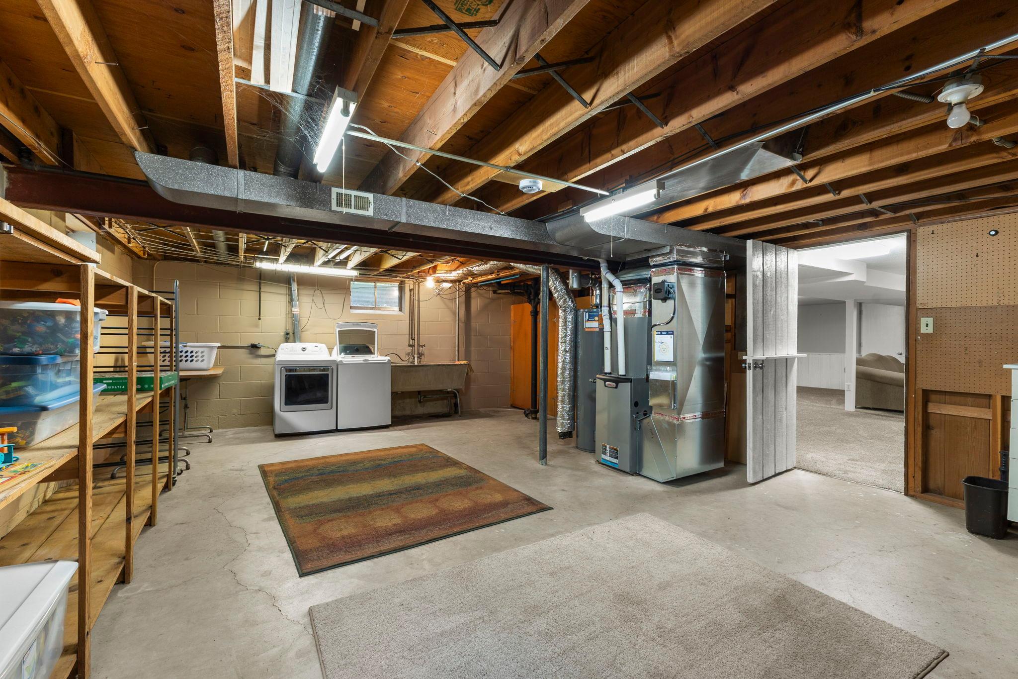 The lower level also offers exceptional storage, along with a laundry area with Kenmore washer and dryer, double-basin utility sink, workbench, and shelving.