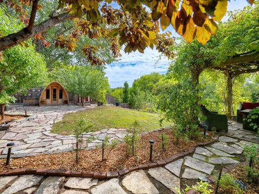 10 - Backyard. A beautiful stone patio leads to a custom 6 person sauna, hot tub and cold plunge.