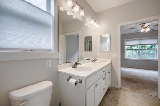Owners bath with step in shower, double vanity, window for natural light and huge walk in closet.