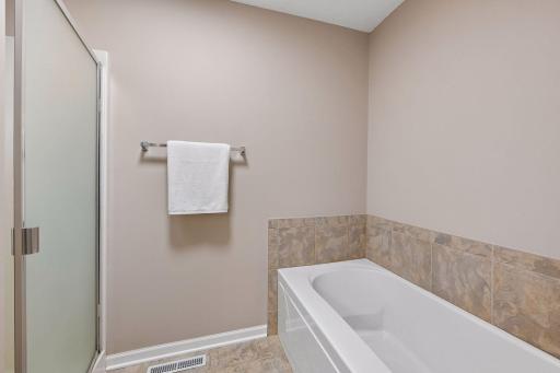 Separate shower and tub in the primary bathroom