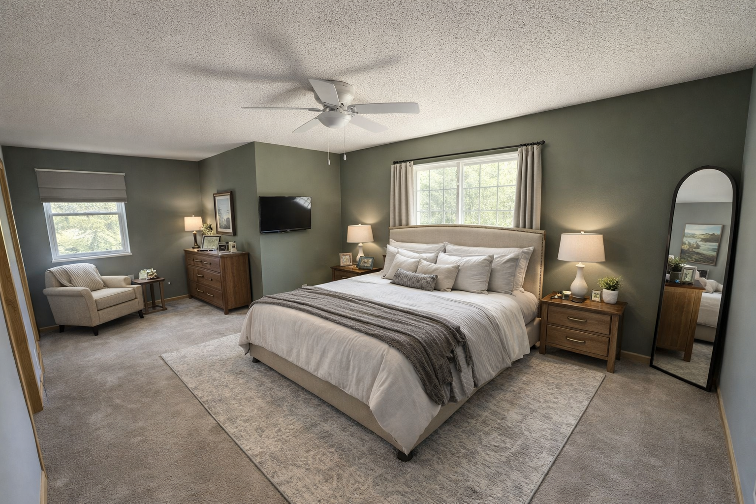Virtually staged Primary bedroom has nook for sitting areawith