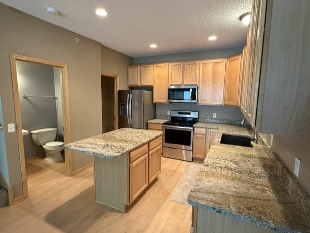 Center Island kitchen with granite counters and SS appliances