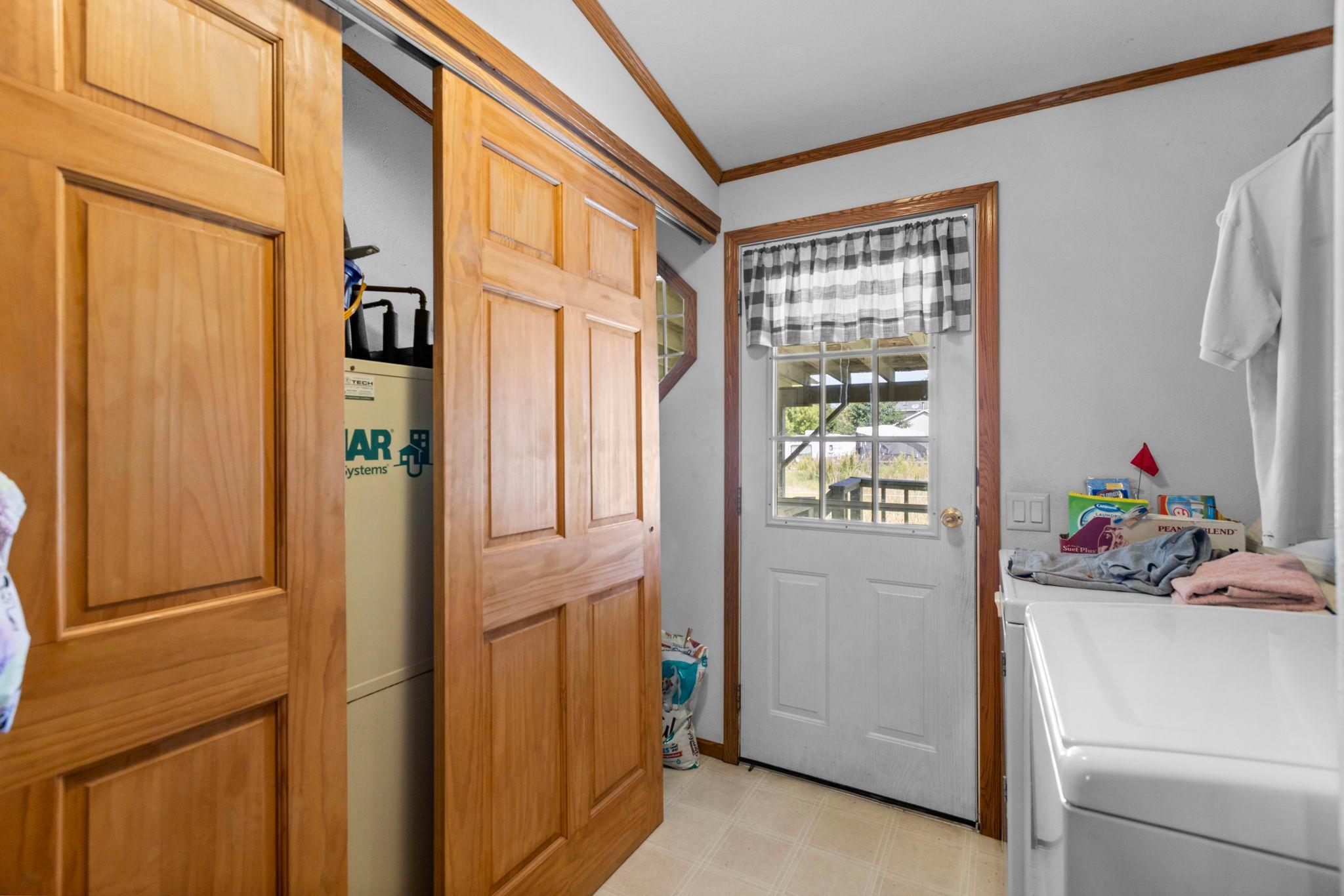From the kitchen there is a rear exit located in the laundry area with utility closet