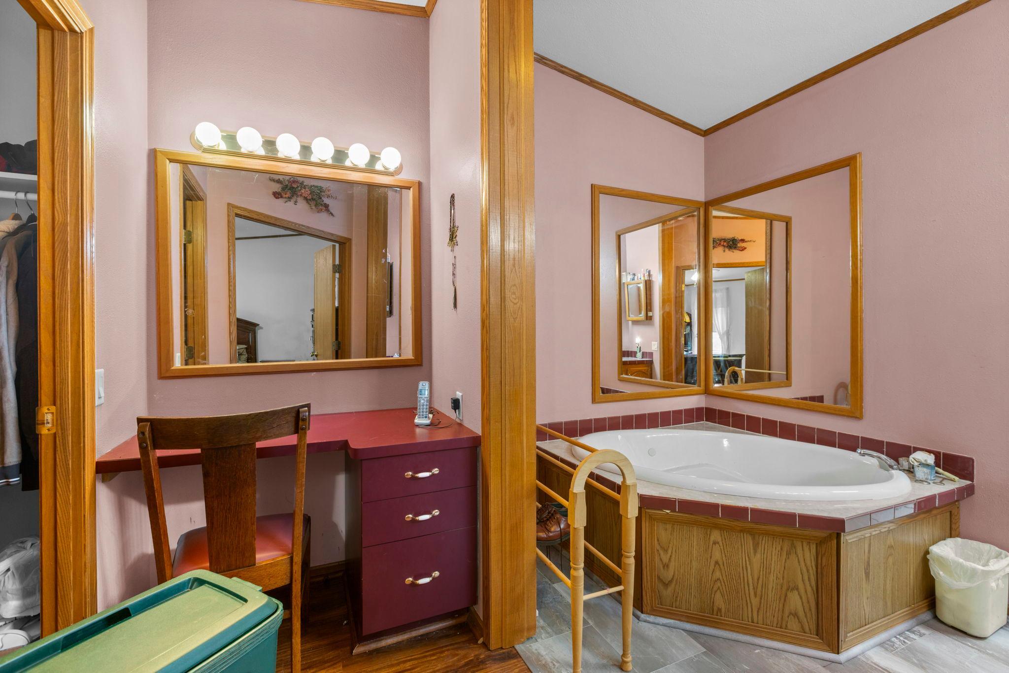 The private bath features a separate vanity & large soaking tub