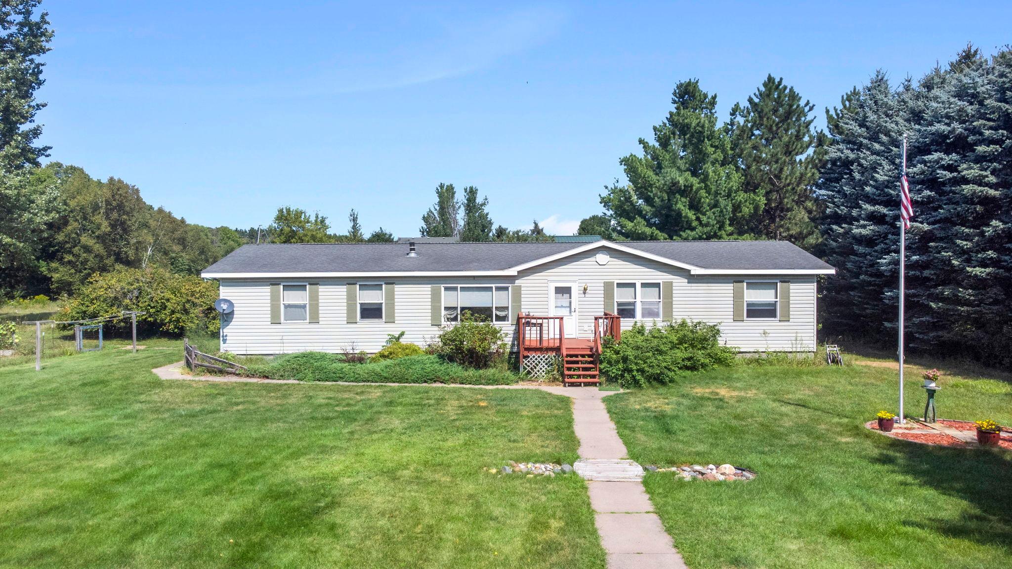 Charming front entry with sidewalk wrapping around to the rear deck area
