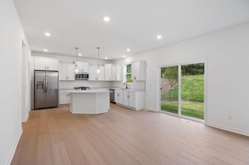 Designer-selected cabinets and quartz countertops frame the kitchen to provide cohesive style and functionality