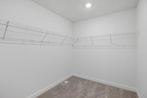 Fit for expansive wardrobes, this oversized walk-in closet comes with mesh-wire shelving to optimize organization and maximize storage space