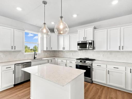 This modern kitchen features a set of brand-new stainless steel appliances, abundant cabinet space and a convenient center island to add seating and counter room.