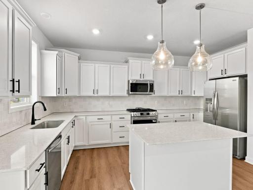 The center island extends out to a breakfast bar for casual meals