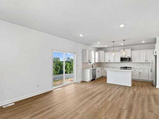 The breakfast room is situated among the open floorplan, allowing for effortless flow between rooms.