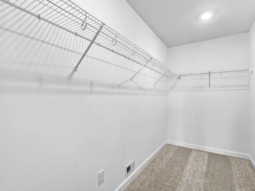 Accessible from the primary bedroom, this large walk-in closet provides abundant storage space for growing wardrobes