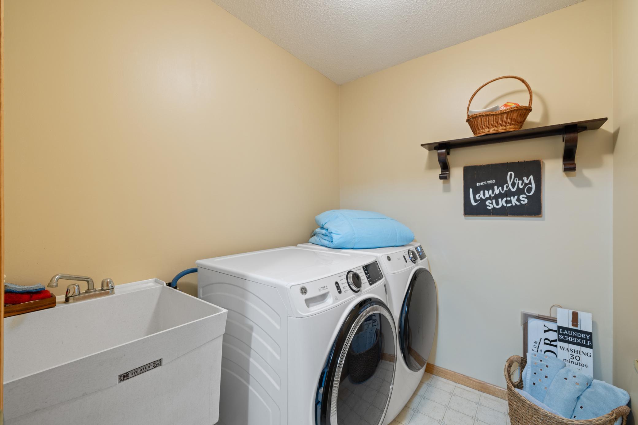 Laundry room is just off the garage entry area. New washer, dryer and laundry sink