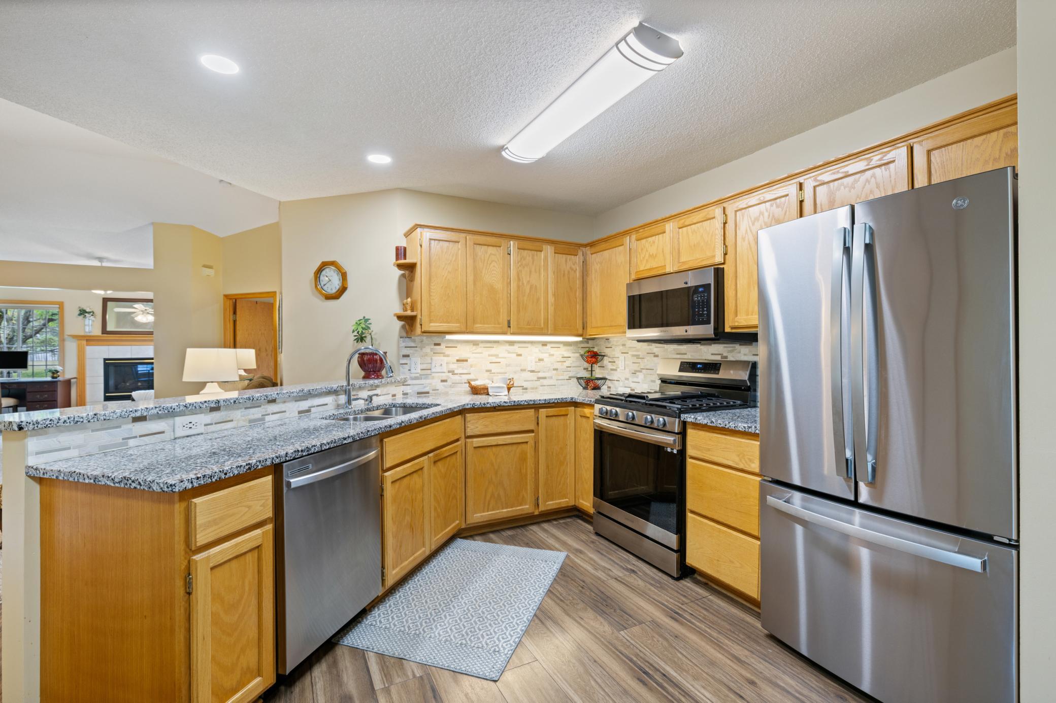Updated kitchen with beautiful granite counters, tiled back spash, stainless appliances and new laminate flooring.