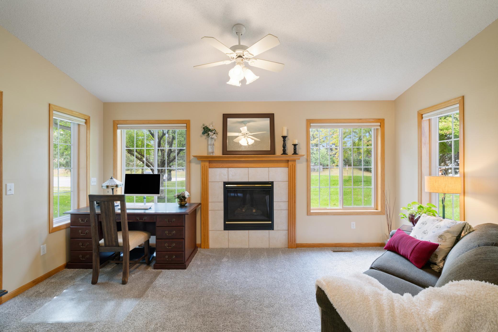 Sun room has a gas fireplace, fan and access to the private back patio.