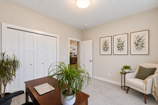 The main floor second bedroom is currently staged as a home office. Conveniently off the front hall.