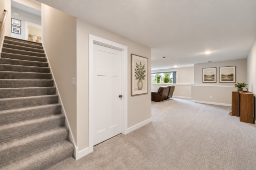 Down stars has an expansive family room with bright windows and gorgeous flooring.