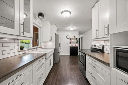 Completely remodeled kitchen with tall cabinets, soft close drawers, stainless steel appliances. Notice far back wall showing room for added functions such as a coffee bar