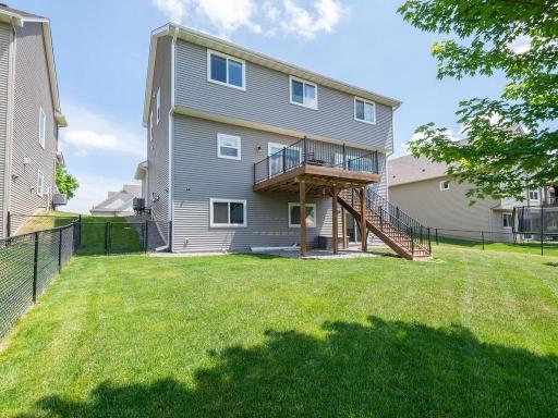 Well-maintained exterior with elevated deck, lower-level walkout access, and fully fenced yard providing privacy and security.