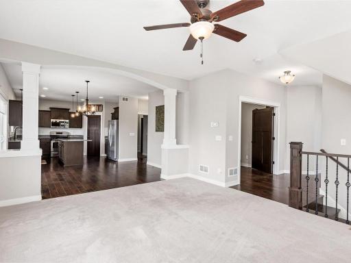 Open concept design at its finest! Spacious living area with soaring ceilings flows effortlessly into the gourmet kitchen, perfect for entertaining and everyday living.