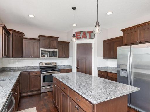 Functional kitchen layout with generous counter space and plenty of storage in custom cabinetry.
