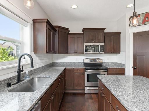 Kitchen detail showcasing the quality finishes and abundant natural light from oversized windows.