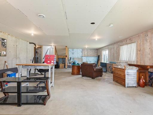 Additional lower-level space offering endless possibilities for customization, with rough-in plumbing available for future bathroom addition.