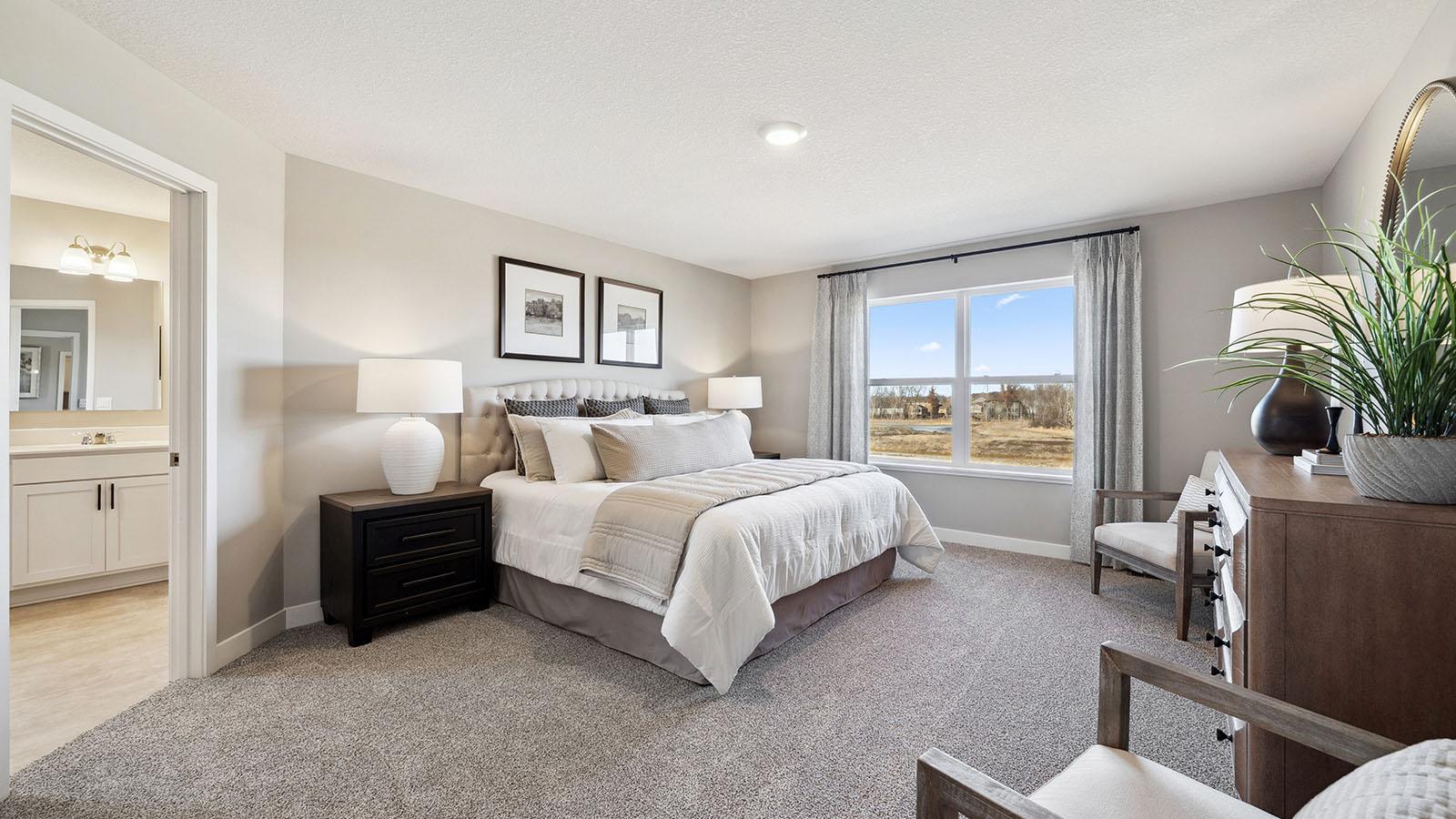 The spacious primary bedroom is sure to fit all of your furniture. Photo of model home, color and finishes will vary.