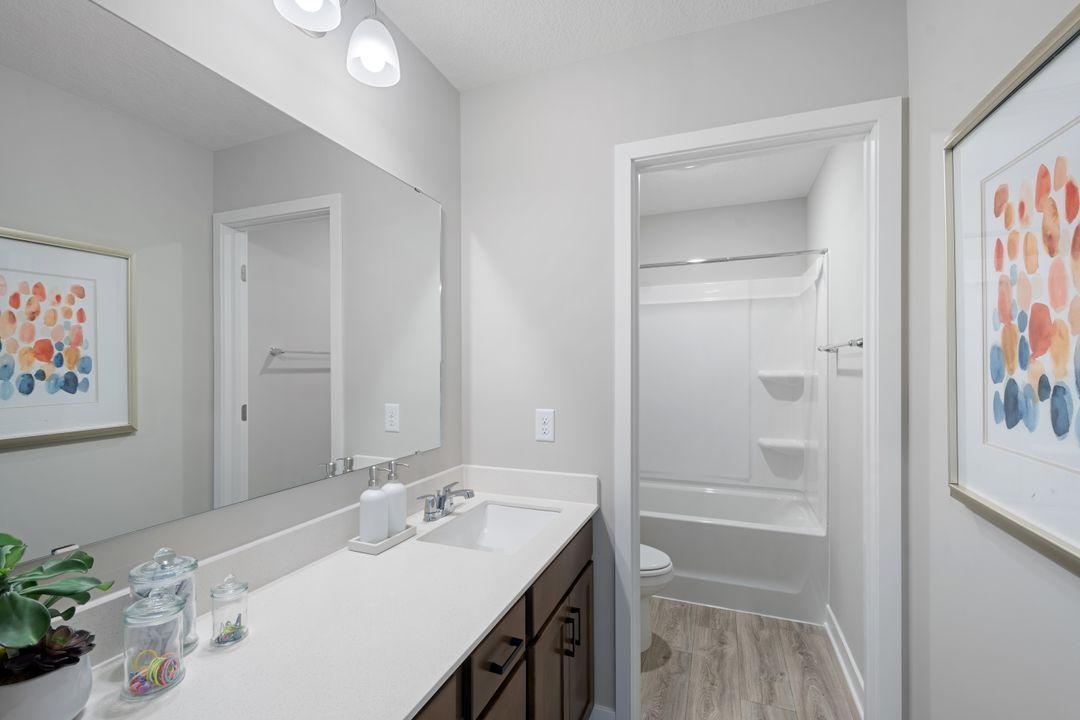 The upper level main bathroom has a separate toilet and shower room convenient for busy mornings. This home will include 2 sinks in this main bathroom. Photo of model home, colors and finishes may vary.