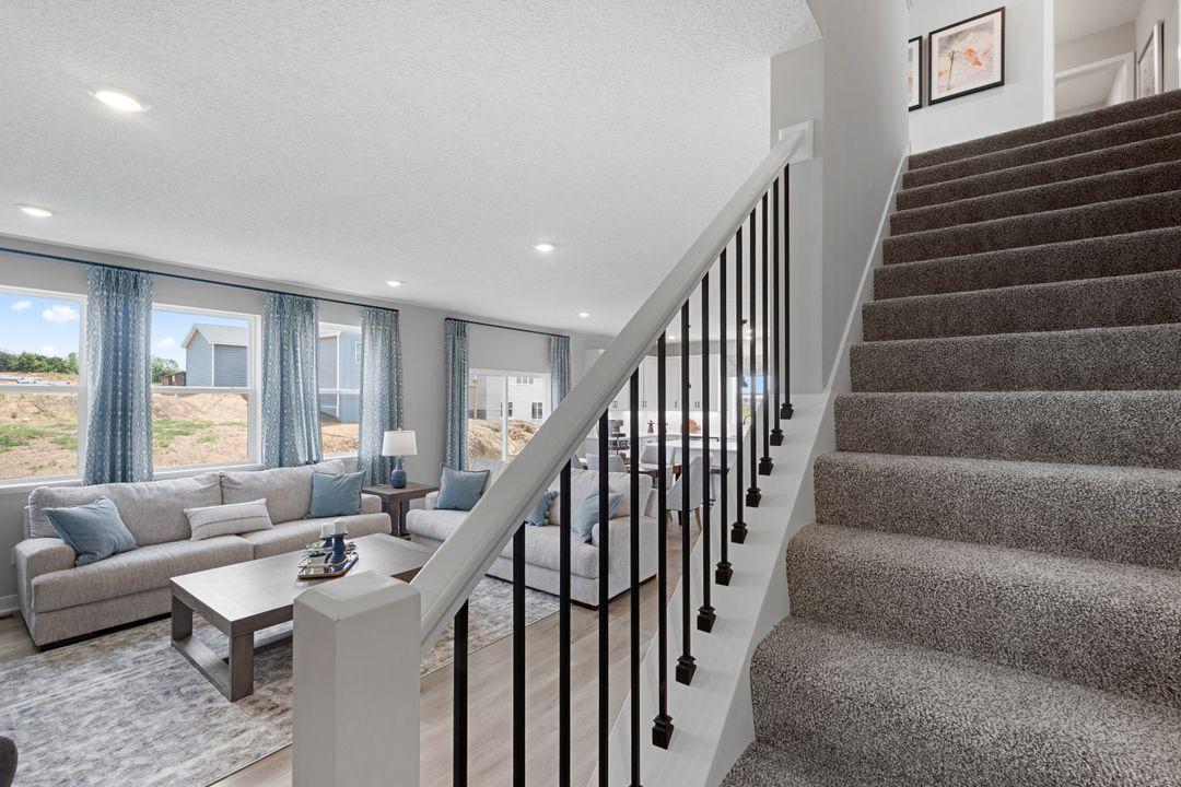 The staircase in the Jordan is extra wide and easy to navigate with furniture on move-in day. Photo of model, colors and finishes may vary.